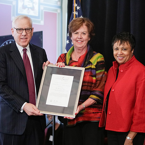 Sharon Darling, representing the National Center for Families Learning, receives the 2017 Library of Congress Literacy Awards American Prize, presented by Librarian of Congress Carla Hayden (right) and David M. Rubenstein (left).
