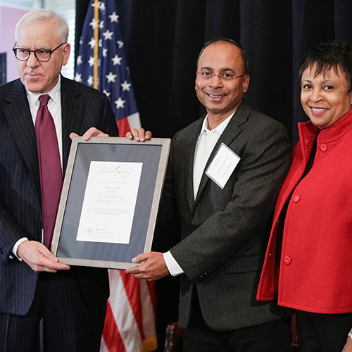 R. Sriram, representing Pratham Books, receives the 2017 Library of Congress Literacy Awards International Prize, presented by Librarian of Congress Carla Hayden (right) and David M. Rubenstein (left).