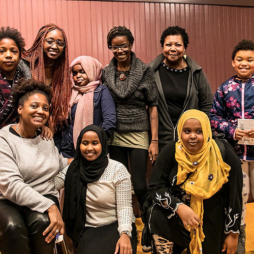 Tracy K. Smith poses with students from the Lewiston 21st Century Program at the Lewiston Public Library in Lewiston, ME. November 1, 2018. Credit: Erik Peterson.