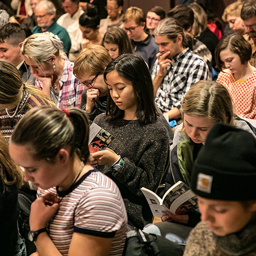 Audience members read along with Tracy K. Smith as she reads poems from 'American Journal' at the Lewiston Public Library in Lewiston, ME. November 1, 2018. Credit: Erik Peterson.