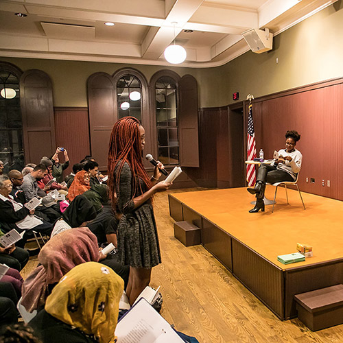 A student in the Lewiston 21st Century Program reads Victoria Chang's poem 'Dear P.' from 'American Journal: Fifty Poems for Our Time' at the Lewiston Public Library in Lewiston, ME. November 1, 2018. Credit: Erik Peterson.