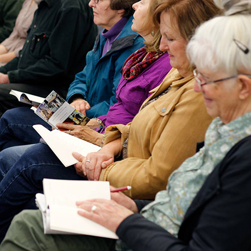 Audience members read along with Tracy K. Smith as she reads and discusses poems from 'American Journal' at the Sturgis Public Library in Sturgis, SD. October 6, 2018. Credit: Ryan Woodard.