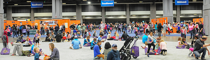 Festivalgoers gather in the Pavilion of the States at the Library of Congress National Book Festival and visit each state with their 52 Great Reads brochure.