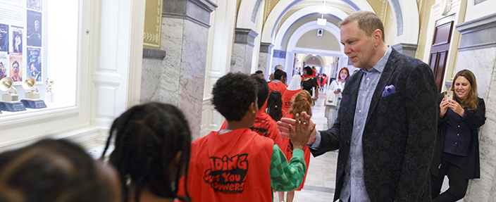 Best-selling graphic novelist Dav Pilkey high fives all 400+ students as they leave his talk about Dog Man and making comic books (10/11/2019).