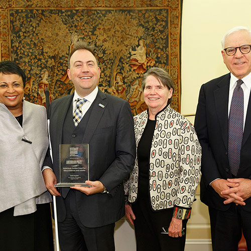 Mark Riccobono and Mary Ellen Jernigan, representing the American Action Fund for Blind Children and Adults, accept the American Prize, presented by Librarian of Congress Carla Hayden and David M. Rubenstein.