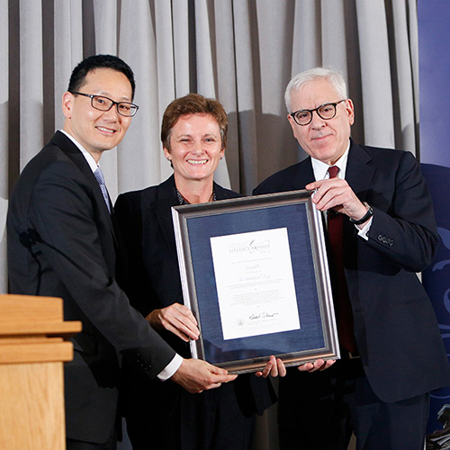 Ginny Lunn, representing Beanstalk, receives the 2015 Library of Congress Literacy Awards International Prize, presented by David M. Rubenstein (right) and Acting Librarian of Congress David Mao (left).