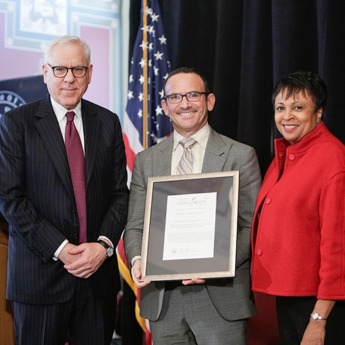 Joel Zarrow, representing the Children's Literacy Initiative, receives the 2017 Library of Congress Literacy Awards David M. Rubenstein Prize, presented by Librarian of Congress Carla Hayden (right) and David M. Rubenstein (left).