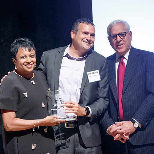 Mark Federman, representing East Side Community School, accepts the American Prize, presented by Librarian of Congress Carla Hayden and David M. Rubenstein.