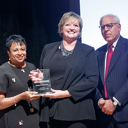 Alicia Levi, representing Reading Is Fundamental, accepts the David M. Rubenstein Prize, presented by Librarian of Congress Carla Hayden and David M. Rubenstein.