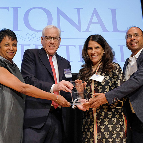 Suzanne Singh and R. Sriram, representing Pratham Books, accept the International Prize, presented by Librarian of Congress Carla Hayden and David M. Rubenstein.